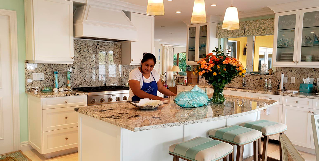 Angelic Maids team member cleaning a kitchen for Airbnb turnover in Boca Raton