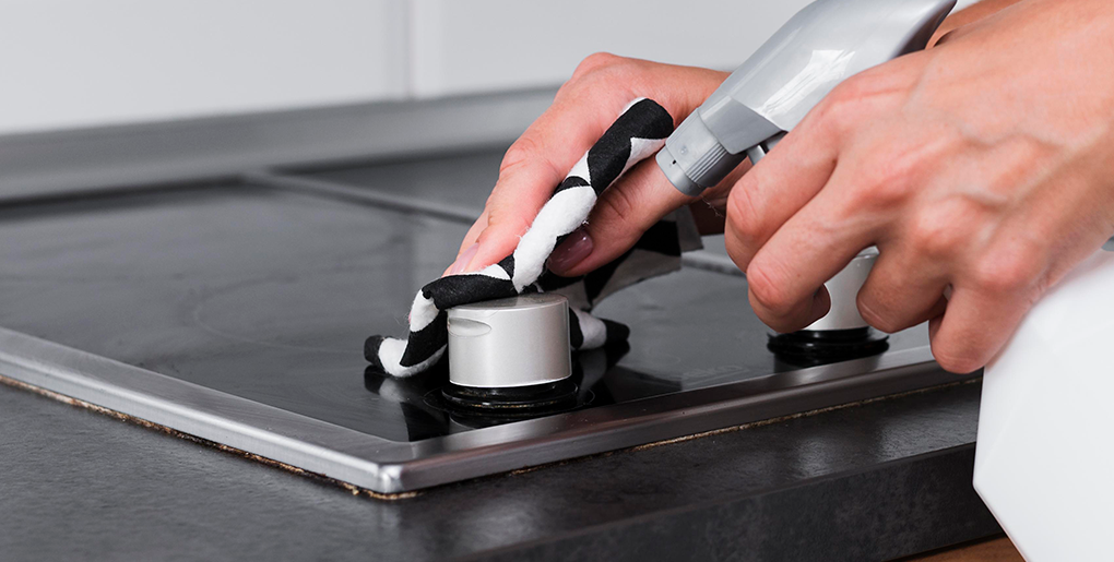 Stove being disinfected as part of high-touch surface cleaning by Boca Raton cleaning services